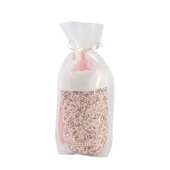 Floral-patterned bottle holder in sheer white fabric tied with a ribbon, part of the ASI Dolls Martina Collection.
