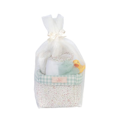 Quilted basket with a yellow duckling, soft towel, and tulle sponge, wrapped in tulle with a ribbon.