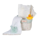Quilted floral basket with diapers, a white towel, small tulle sponge, and yellow rubber duck for 36-50 cm dolls.