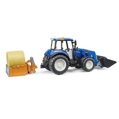 Blue New Holland T5.120 toy tractor with frontloader, large black wheels, and yellow hay bale attachment on white background.