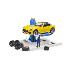 Yellow toy roadster on blue lift at Bruder Car Service Center with mechanic and spare tires.