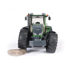 Front view of Bruder Fendt 936 Vario toy tractor, green with large black tires, on white background.