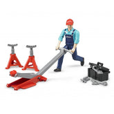 Mechanic figure with red cap and blue overalls using a garage jack, flanked by tools and red jack stands.