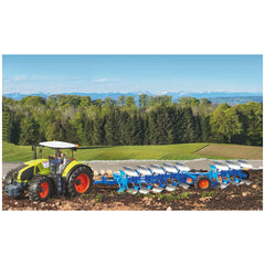 Bruder LEMKEN plough attached to a green tractor on a vibrant field with a forest and mountains in the background.