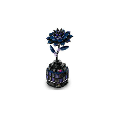 Stunning black dahlia flower made of LEGO bricks atop a decorative vase resembling a mini conservatory with colorful windows.