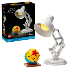 LEGO Disney Pixar Luxo Jr. model displaying a white articulated lamp beside a colorful star-patterned ball on a brown base.