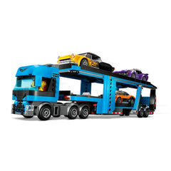 LEGO® City Car Transporter truck in vibrant blue with a detailed cab, loaded with a classic yellow car and two sports cars, parked on a dual-level trailer.