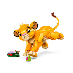 LEGO® Disney Simba from The Lion King, in a playful pose, with movable legs and tail, next to colorful leaf and bug builds.