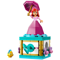 LEGO Disney Princess Twirling Ariel construction set featuring Ariel in a pink dress with an umbrella, standing atop a colorful block base, accompanied by Flounder the fish.