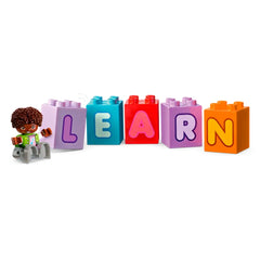 Colorful LEGO® DUPLO® bricks spell "LEARN," accompanied by a cheerful toddler figure with curly hair, ready for creative play.