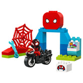 LEGO DUPLO Marvel Spin’s Motorcycle Adventure set featuring a Spider-Man figure on a black motorcycle, a red spider web, and colorful building elements.