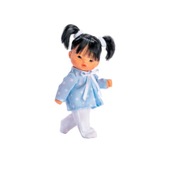 Cheni doll in blue star shirt, white leggings, with black pigtails, stands posing on a white background.