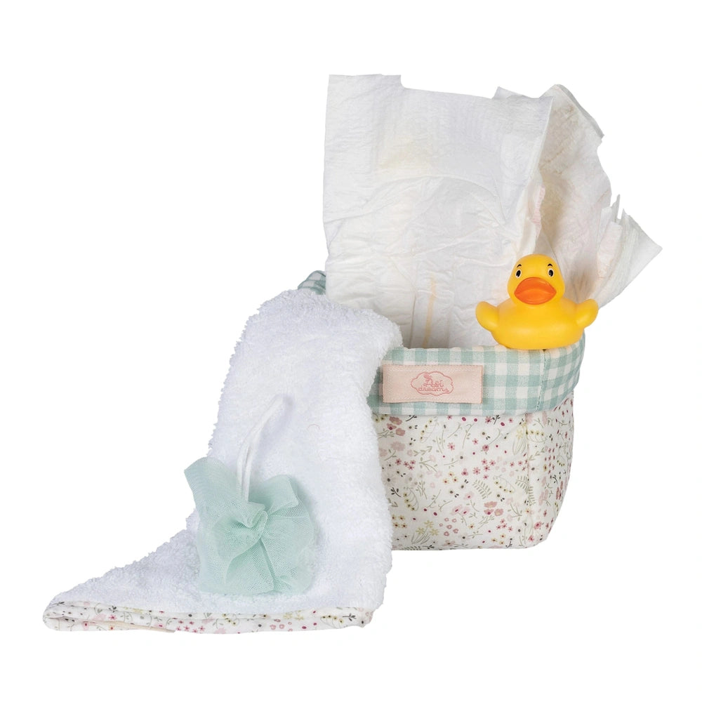 Quilted floral basket with diapers, a white towel, small tulle sponge, and yellow rubber duck for 36-50 cm dolls.