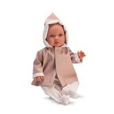 ASI Dolls Leo wearing a pink raincoat and floral pajamas, sitting with an arm raised, featuring expressive eyes.