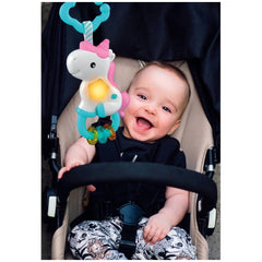 Baby Clementoni Magic Unicorn Light & Melodies toy with a pink mane and blue horn is held by a smiling child in a stroller.
