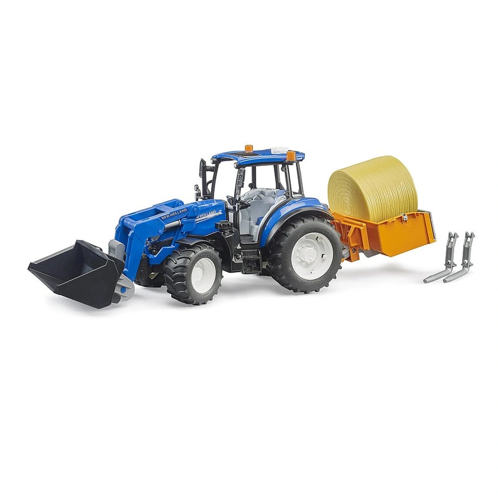 Blue New Holland toy tractor with frontloader, yellow hay bale on trailer, and detached forks, showcasing agricultural play.