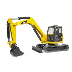 Yellow Bruder Cat Mini Excavator toy with realistic features, tracked chassis, and articulated arm on white background.