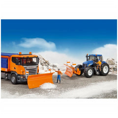Orange toy truck and blue tractor with plow blades clearing imaginary snow, set against a bright sky.