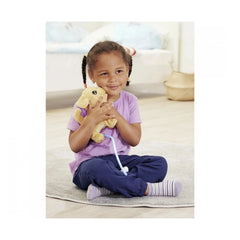 ChiChi LOVE Loomy Golden Retriever plush toy is being joyfully held by a smiling child sitting on a textured rug indoors.