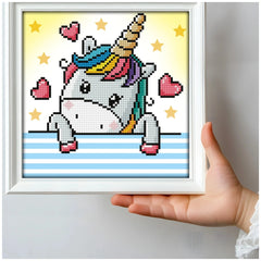 DIAMOND DOTZ Dotzies U Baby diamond painting featuring a colorful unicorn with red hearts and yellow stars on a white frame.