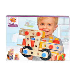 Eichhorn Constructor 4 in 1 construction set features a smiling child holding a colorful wooden toy with wheels.