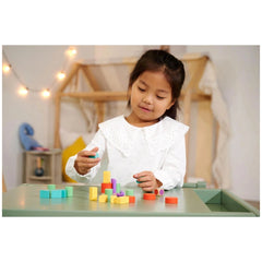 Eichhorn Sorting & Stacking Toys displayed with a girl in a lace-collared outfit playing with colorful building blocks.