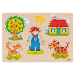 GOKI Cat Dog Lift-Out Puzzle packaging features a boy with a blue shirt and red hat, surrounded by a vibrant outdoor scene.