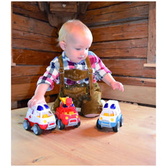 Gowi concrete mixer toy in use by a child in plaid shirt and brown suspenders, holding a colorful toy car in a lifestyle scen