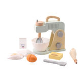 Johntoy mixer set features a wooden toy sewing machine, white bowl, orange egg, yellow box, and various tan kitchen utensils.