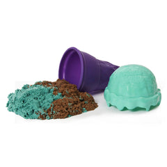 Kinetic Sand Ice Cream Cone Container features a purple lid filled with brown sand and a textured green container beside it.