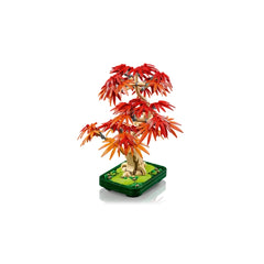 Colorful LEGO® Botanicals Japanese Red Maple Bonsai Tree with vibrant red and orange leaves, set in a dark green pot with decorative grass elements.