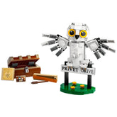 LEGO Harry Potter set featuring Hedwig, the snowy owl, with wings spread, perched on a 'Privet Drive' sign, alongside a treasure chest and wand.