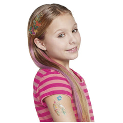 Young girl with long pink and purple hair wearing a pink and white striped shirt, adorned with colorful tattoos and stickers.