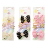 Classy ribbon hair clip set featuring three bows in black and pink with glittery stars, presented in a white packaging.