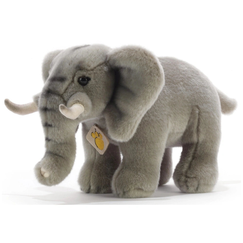 Gray plush Tyke Little Elephant with white trunk and tusks, lighter gray ears, and shiny black eyes, centered on a light back