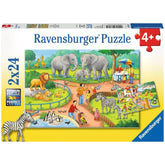 Ravensburger puzzle box featuring a vibrant zoo scene with elephants, zebras, birds, and people interacting with animals.