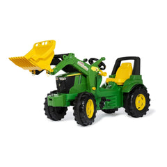 Rollyfarmtrac John Deere 7310R toy tractor in green with yellow bucket attachment, set against a white background.
