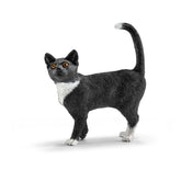Schleich cat figure in black with white chest and paws, made of matte material, features a curved tail and four legs.