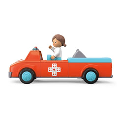 Toy truck in orange with blue and white accents, featuring a prominent red cross, smooth plastic surface, and striped pattern