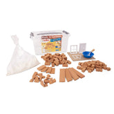 Teifoc basic construction kit includes a container, craft material bag, wooden planks, and a blue bowl on a white surface.