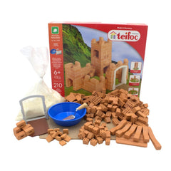 Teifoc castle building set featuring brown, beige, and green bricks alongside a small blue bowl in a clear display box.