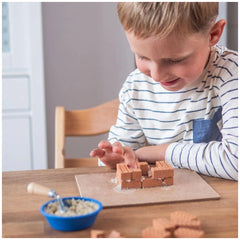 Teifoc castle building blocks set is being used by a young child engaged in creative play at a wooden table.