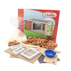 Teifoc construction set featuring brown and white plastic bricks, a wooden house model, and a cardboard base for creative bui
