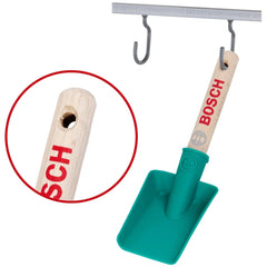 Theo Klein Bosch garden hand shovel with a wooden handle, green scoop, and metal hooks, featuring a smiley face logo.
