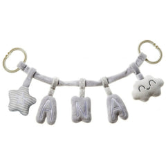 Plush grey letters "A", "N", "A" between star and cloud on hanging toy bar with rings.