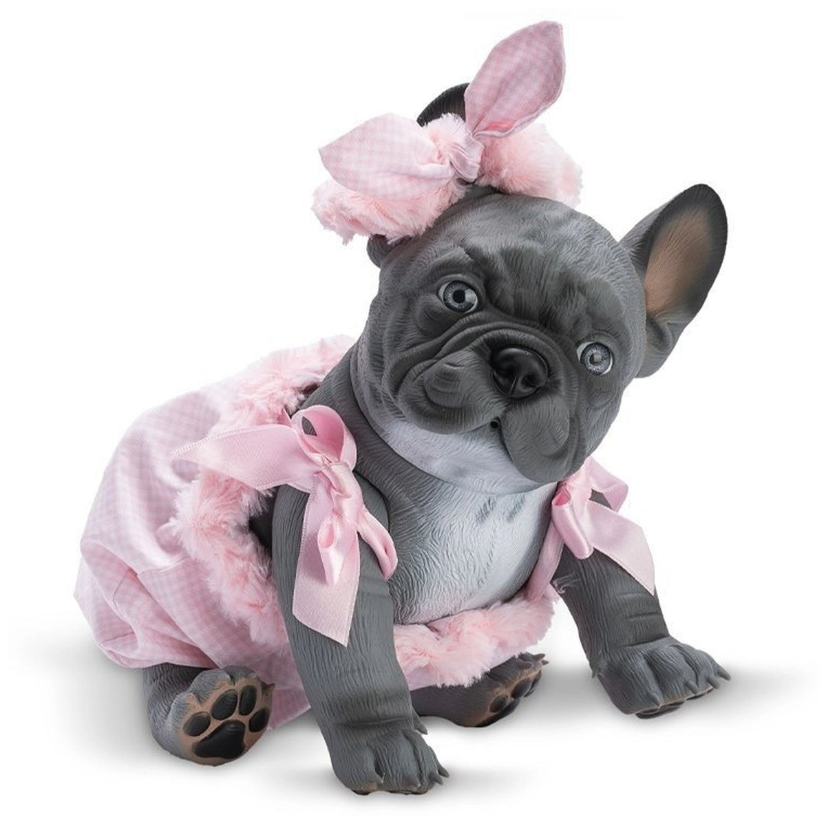 Gray bulldog doll in pink romper with bows sitting on white background, looking forward with tilted head.