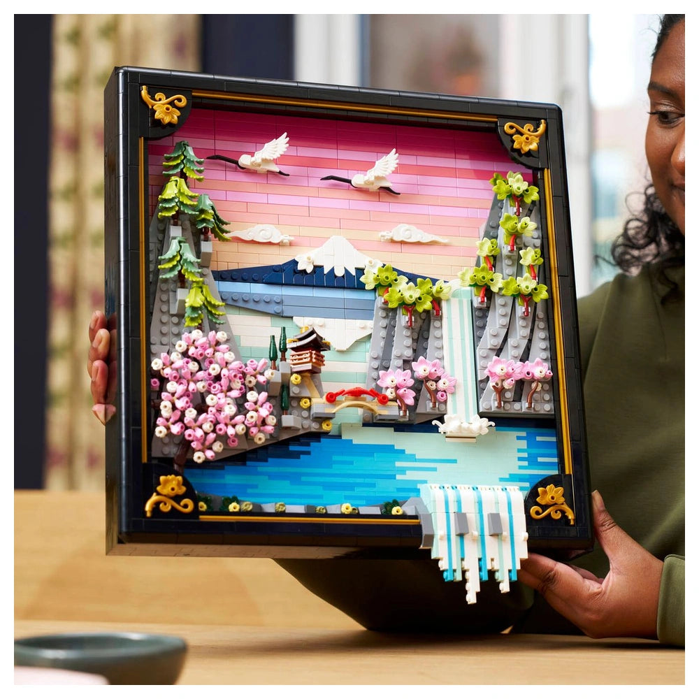 LEGO Art set featuring a colorful Japanese cherry blossom landscape with water, an island, mountains, and a gradient sky.