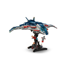 LEGO Avengers Quinjet construction set featuring an intricately designed aircraft in blue and silver, displayed on a black stand. Minifigures of superheroes in action positions surround the Quinjet, enhancing the Marvel theme.