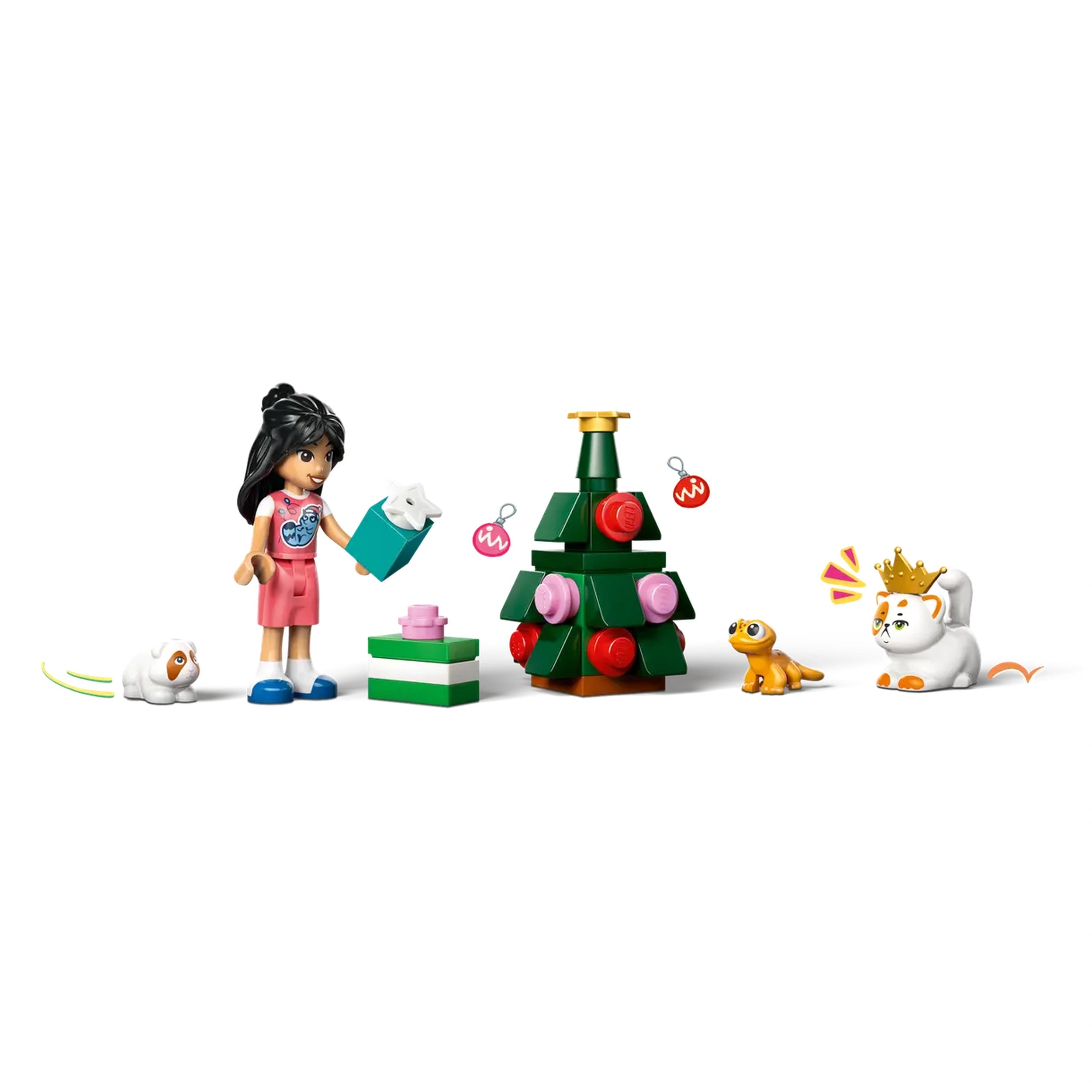 A child with black hair holds a gift box beside a decorated green LEGO Christmas tree. Two playful animals, a white dog and a small gecko, sit by a stack of colorful presents, with a crown-wearing white cat nearby.