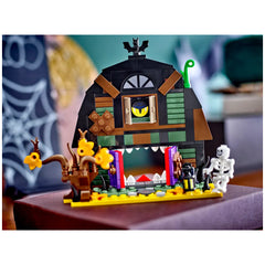 LEGO Halloween Barn set featuring a spooky barn with a monstrous mouth, vibrant doors, and a skeleton minifigure, surrounded by autumnal decor.